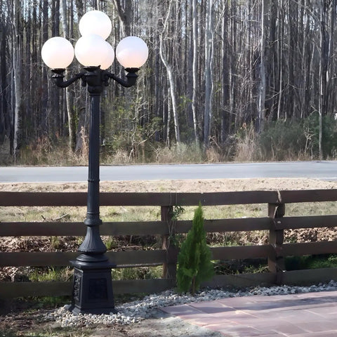 9.5 Ft Five Arm Victorian Outdoor Post Light in Black Finish with shatterproof globe shades along pathway and wooden fence