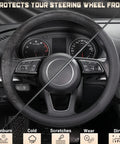 Premium Black Microfiber Leather Steering Wheel Cover For Cars And Trucks Super Soft Anti Slip Grip Easy Peasy Install Fits Standard 15 Inch Wheels on vehicle dashboard.
