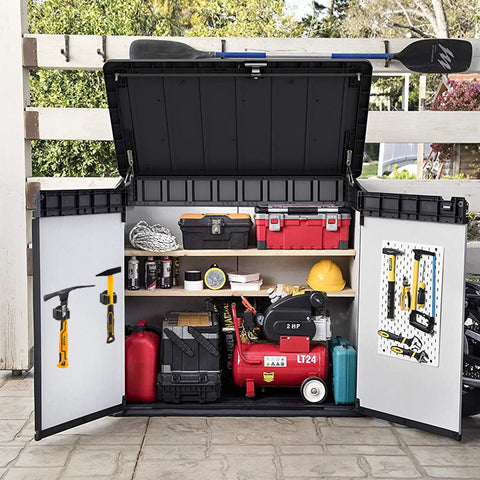 Outdoor storage shed with assorted tools and equipment, open doors displaying shelves and hooks on the doors.