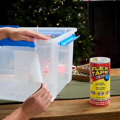 Person applying Thick Rubberized Waterproof Tape For Patching Sealing Leaks And Quick Repairs That Works Underwater And On Dry Surfaces Ideal For Home RV Roof Plumbing And Pool Maintenance Clear 8 In X 5 Ft to plastic container next to a roll of the tape.