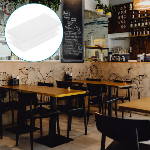 20 Pack White Plastic Square Chair Leg Caps With No Slip Grip And Stable Glide End Inserts in a café setting