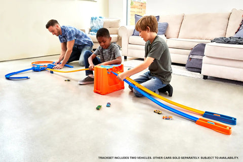 Kids playing with Deluxe Stunt Box Track Builder Playset With 25 Parts And A 1 To 64 Scale Vehicle Easy Build And Quick Cleanup