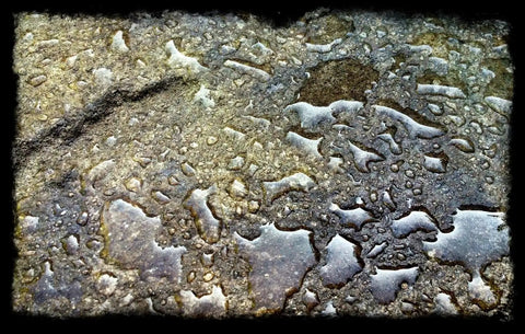 Water droplets on a concrete surface showcasing Heavy Hitter Water Repellent Concrete Sealer Boasting A Natural Matte Finish Water Based Low Voc Formula For Driveways And Patios Drops Ultimate Storm Shield Protection Without Gunky Shiny Buildup Inside A Chunky Five Gallon Container.