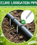 Heavy Duty Galvanized Garden Stakes 5 Inch 25 Pack With Anti Rust Ground Pins For Weed Barrier Fabric supporting irrigation pipe in garden soil.