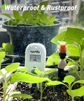 Smart Wireless Plant Moisture Meter With Visual Gauge in planter, showing moisture level, surrounded by indoor garden greenery.