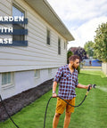 Man using Solid Brass Garden Hose Quick Connectors Set 3/4 Inch GHT Thread Includes Six Male and Six Female Connectors Plus Teflon Tape Washers and O Rings for Leak Proof Heavy Duty Rust Proof Performance to water lawn.