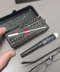 All In One ESD Safe Go Box Micro Bits Set With 39 Pieces Including Slotted Phillips Hex Torx Pentalobe Bits Micro Bit Handle And 100mm Extension Built For Fast Electronics Repairs And Precision Work, shown open on table with lenses.