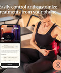 Woman using Four In One Back Wrap With Heat, Far Infrared, Vibration, And LED Therapy for epic lower back pain relief at home with phone app