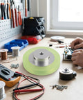 Beefy Rotary Encoder Meter Wheel With 6mm Aperture For Marking Machines And Inkjet Printers, shown on a workbench