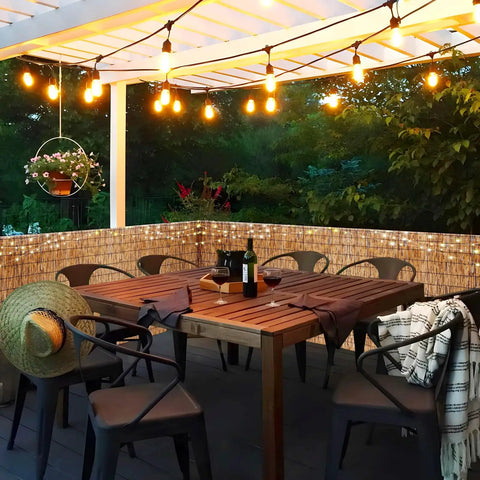 Privacy Bamboo Fence Roll For Outdoor Spaces Coffee Color 2.6x6.6ft With Cable Zip Ties shading a cozy lit patio