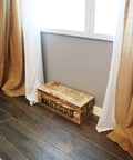 Large Wooden Cable Management Box For Home And Office beneath curtains in a room.