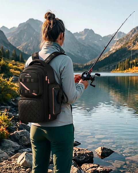 Woman fishing by the lake with a Women's Fishing Sling Bag With Lure Rod Holder And Phone Pouch Waterproof 3600 Tackle Backpack in black.