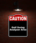 Golf Swing Area Caution Sign Red Black Aluminum Composite 8.5 x 10 Inches on brick wall under light