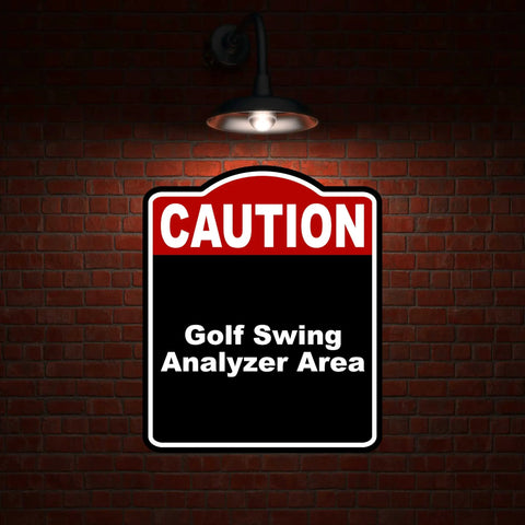 Golf Swing Area Caution Sign Red Black Aluminum Composite 8.5 x 10 Inches on brick wall under light
