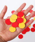 Totally Kid Approved Two Color Counters 100 Pack In Heavy Duty Plastic Case held in hand, vibrant red and yellow discs for math activities.