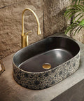 Retro Ceramic Vessel Sink for Bathroom, Oval Above-Counter Wash Vanity Sink with Accessories on a stone countertop.
