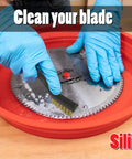 Hands cleaning a saw blade in a red silicone tray with a wire brush, part of the Deluxe Saw Blade Cleaning Kit With Silicone Tray And 18oz Spray Cleaner Includes Trend Tool And Bit Cleaner Fulton Wire Brush Set And All In One Blade Care For Rust Removal And Mess Free Maintenance Up To 12 Inches Pro Grade.