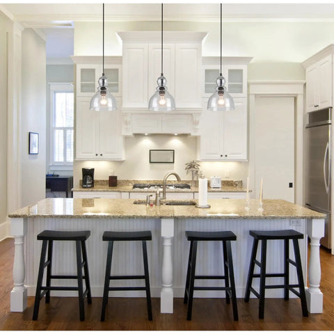 Two Pack One Light Adjustable Mini Pendant With Hand Blown Clear Seeded Glass In Oil Rubbed Bronze Finish over a kitchen island.