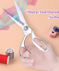 Hand holding stainless steel sewing scissors from Handheld Sewing Machine With Elegant Wooden Box And 153 Piece Kit.