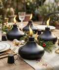 Upgraded Tabletop Torch Set Of 6 With 24.5 Oz Citronella Fuel Refillable Metal Lanterns on dining table setup outdoors.