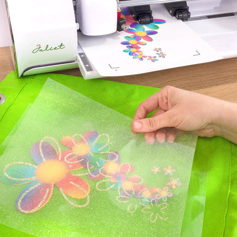 Hand holding EasyColor DTV Printable Heat Transfer Vinyl Sheet for Inkjet Printers 8.4 x 11 inches with floral design on green fabric.
