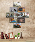 Assorted vintage travel and motorcycle themed posters displayed on a rustic wall above a shelf with books and decor items.
