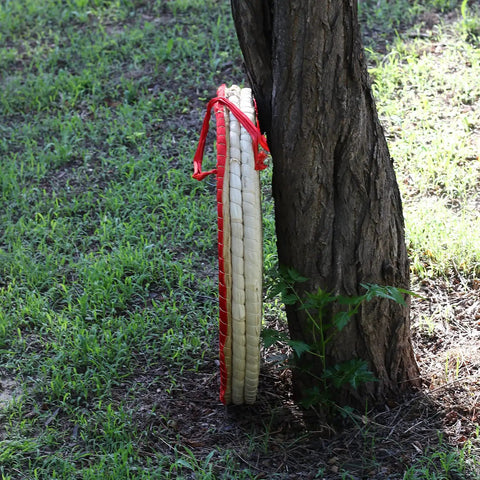 Backyard Archery Target For Adults And Youth, Easy Arrow Removal And Durable Straw Target For Outdoor Practice leaning on a tree