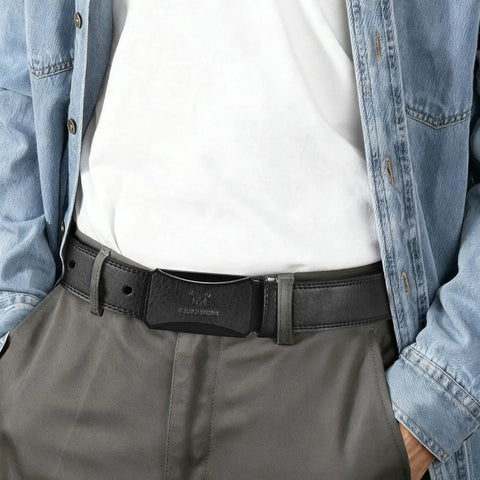 Man wearing TSA Approved Nickel Free Hypoallergenic Plastic Belt With No Metal Buckle For Men Black Leather Look Breeze Through Airport Security Scratch Resistant Comfortable Fit Belt That Wont Dig In Or Cause Allergies with jeans and white shirt.