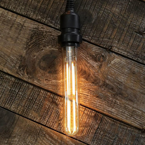 Dimmable T10 Amber LED Tubular Bulb 6W 60W Equivalent, Retro Edison Style Light; warm glow on rustic wooden surface