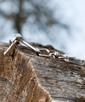 Pro Grade Logger Tape 15 Meter Clear Measuring Tool for Pros on rough lumber surface in fieldwork setting