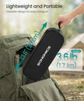 Foldable Portable Camping Chair With 330 Pounds Capacity in carrying bag, being packed into backpack next to tent outdoors.