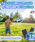 Child flying UFO Drone For Kids With Colorful LED Lights, Remote Control Helicopter With Auto Hover, showing dual battery feature.
