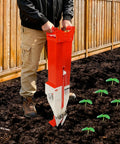 Easy To Use Manual Vegetable Seeder And Fertilizer Tool, Handheld Garden Planter used in a garden with corn seedlings