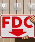 Heavy Duty FDC Sign With Down Arrow 18 X 12 Inch 0 040 Aluminum Fire Department Connection Plate held up, showing reflective surface.