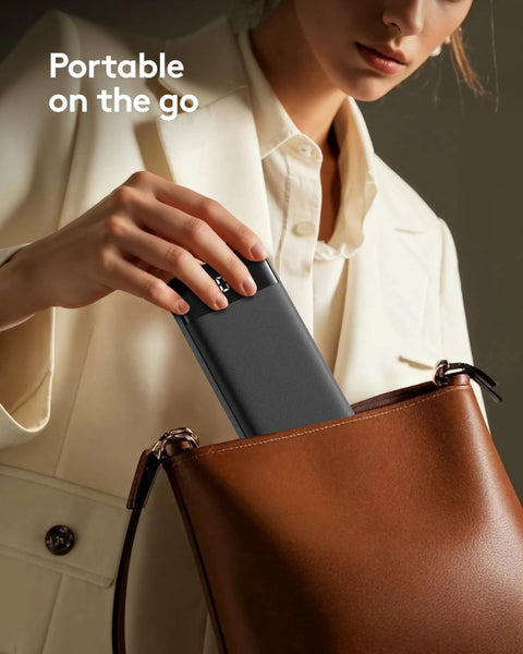 Rugged Portable Power Bank Delivering 22.5W Fast Charging Through Four Built In Cables For Plug And Play Convenience in a handbag.