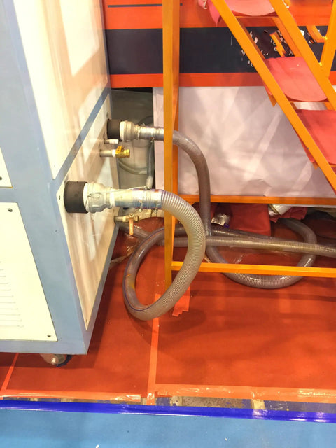 Clear Wire Reinforced Suction Hose 2 In ID X 2-5/16 In OD 10 Ft connected to machinery for fluid transfer.