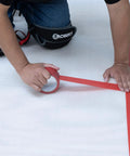 No Nonsense Foam Underlayment Roll Quiet Room Padding for Laminate being installed with red tape on foam surface.