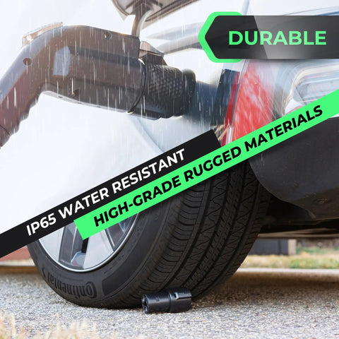 Gotta Love J1772 To Tesla Adapter Rock Solid Level 2 Portable Power Connector near tire, showcasing IP65 water resistance.