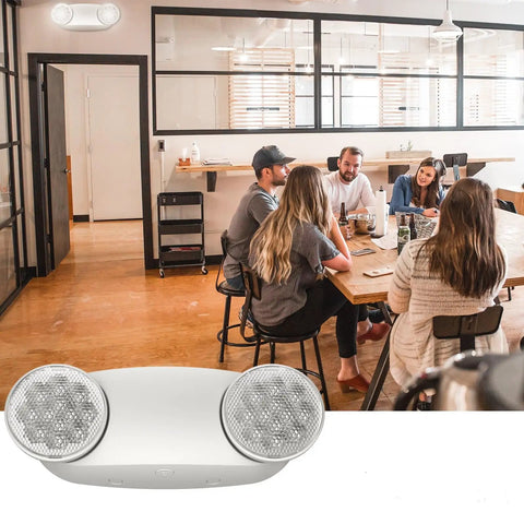 Two Pack White LED Emergency Lights With Battery Backup, featuring two head adjustable fixtures, mounted in a modern office setting.