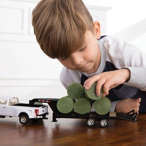 Child playing with Ford Pickup With Gooseneck Trailer Bale Holder And Bales Farm Toy Set For Kids Realistic Farm Hauling Vehicle