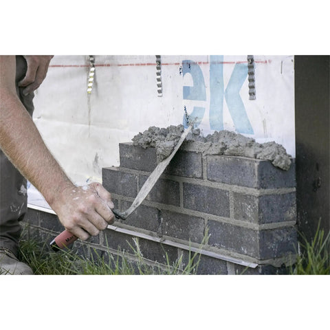 Worker using London Style Pro Grade Brick Trowel With DuraSoft Handle For Brickwork Blockwork And Stonework Ten And One Half Inch By Four And Three Quarters Inch Forged High Carbon Steel Made In USA Masonry Tool on brick wall