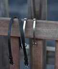 Premium English Leather Spur Straps For Equestrian Riding, 20 Inch Black, Half Inch Wide, on wooden fence with stainless spurs