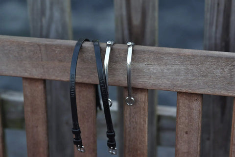 Premium English Leather Spur Straps For Equestrian Riding, 20 Inch Black, Half Inch Wide, on wooden fence with stainless spurs