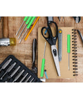 12 Pack Green Pocket Screwdrivers Magnetic Mini Tops with single blade heads on a workbench with scissors and tools