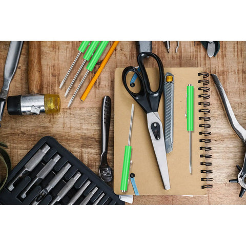 12 Pack Green Pocket Screwdrivers Magnetic Mini Tops with single blade heads on a workbench with scissors and tools