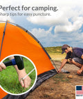 Man securing tent with 30 Pack Tent Stakes 9 Inch Galvanized Steel Ground Spikes With 1 Inch Hook Built Tough Rust Resistant 8 Gauge For Tents Fences Tarps Decorations Inflatables Outdoor Use Made In USA