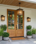 Exterior view with Hillcrest 13 Inch Mission Style Outdoor Wall Sconce Imperial Bronze with Linen Glass beside a wooden door