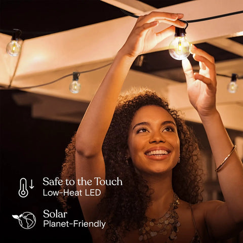Woman adjusting Solar Powered LED Outdoor String Lights 27 Ft Warm White Edison Bulbs for patio backyard porch