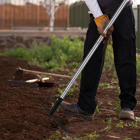 Person using 15 Inch Wide Bow Rake With 16 Steel Tines And Stainless Steel Handle For Loosening Soil Leveling Mulch Gathering Leaves And Lawn Care Built Tough Garden Tool in a garden
