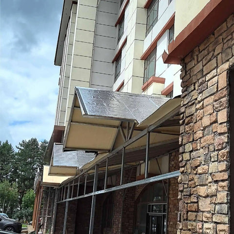 Real Deal Asphalt Roof Repair Tape, All Weather Waterproof Sealant Roll on a building awning for durable leak protection.